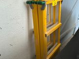 a ladder that is leaning against a wall with a handle