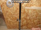 a picture of a metal stand in a room with plywood walls