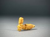 a close up of a small figurine of a person holding a banana