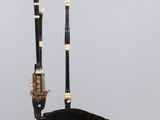 an image of a pair of black and gold flutes with a black bag
