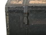 an old black trunk with a lock on it