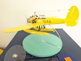 a yellow model of a small plane on a table