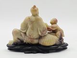 an image of a figurine of a man sitting on top of a shell