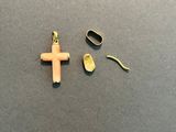 a small cross and a pair of scissors on a table