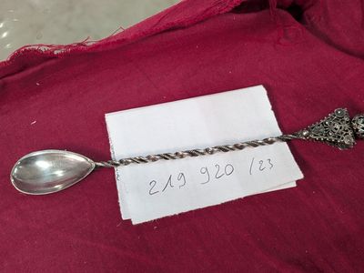 a silver spoon and a silver spoon on a red cloth