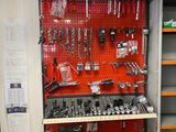many tools on the shelf in the garage