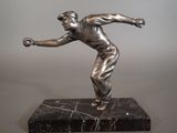 statue of a man throwing a baseball on a marble base