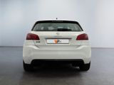 the rear end of a white car in a white room