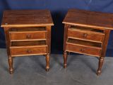 pair of wooden nightstands with drawers on each side of them