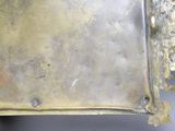 a metal tray with a metal handle on a table