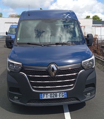 a blue van that is parked in a parking lot