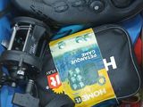 a box full of items that include a pair of shoes, a camera, a book, and a pair of shoes