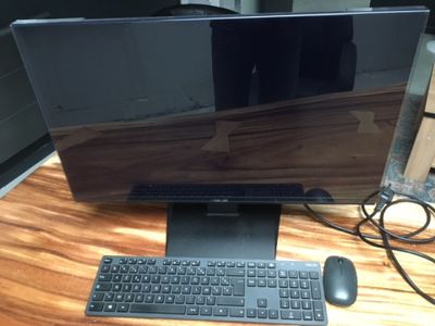 an image of a computer monitor and keyboard on a desk