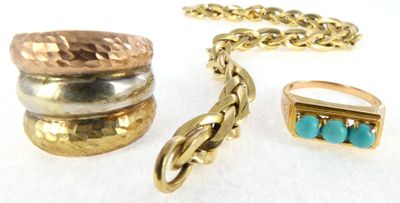 several different rings and bracelets sitting on a white surface