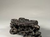 a sculpture of a tree stump with a bird on top of it