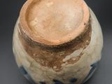 a close up of a vase on a black surface