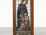 someone pointing at a stained glass window with a picture of a man and a woman