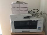 a printer sitting on top of a stack of boxes