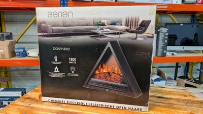 a box with a fireplace inside of it sitting on a table