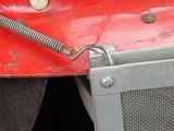 a close up of a red truck with a metal grill