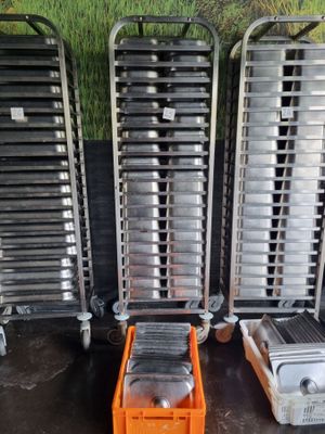 several trays of food sitting on top of a table next to each other