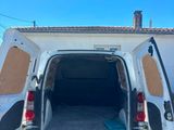 the back of a white van with its doors open in front of a house