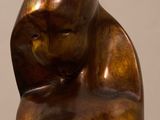 bronze sculpture of a woman holding a baby on a marble base