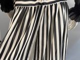 a close up of a mannequin wearing a black and white striped dress
