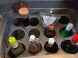 a sink filled with bottles of alcohol next to a bottle opener