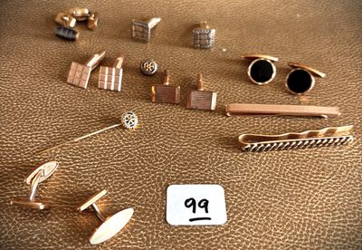 many different types of jewelry on a brown leather surface