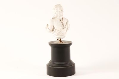 a statue of a man on a pedestal on a white background