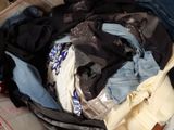 a suitcase full of clothes sitting on the floor