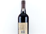 a bottle of wine sitting on top of a white table