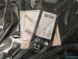 a picture of a black jacket with a white label on it