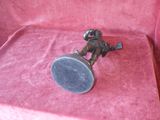 a small metal object on a pink cloth