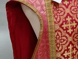 an image of a mannequin wearing a red and gold dress