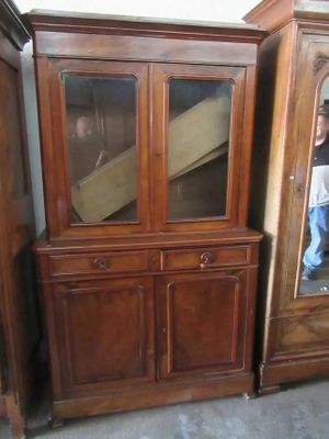 a wooden cabinet with a mirror on top of it