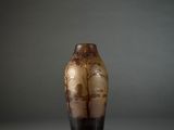 a vase with a tree design on it sitting on a table