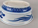 a blue and white bowl with a design on it