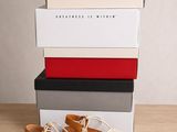 a pair of sandals sitting on top of a stack of boxes