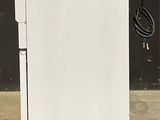 an image of a small white refrigerator in a room