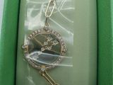 an image of a watch in a box with a chain around it