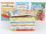 several children ' s books sitting on top of each other on a white surface