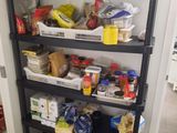 a black shelf filled with lots of food in a kitchen