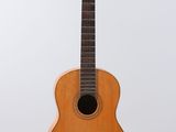 a close up of a wooden guitar on a white background