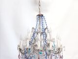 a blue chandelier hanging from a black lamp shade