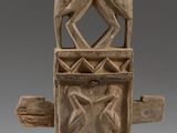 a close up of a wooden sculpture with two birds on it