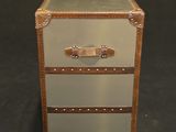 a brown and silver suitcase sitting on a black surface