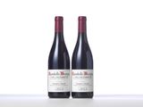 two bottles of red wine sitting on top of a table