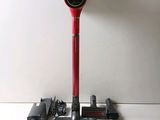 a red and black vacuum on a white table
